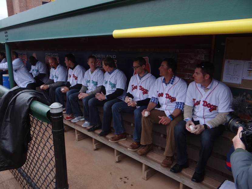 Alums patiently waiting in the dug out.